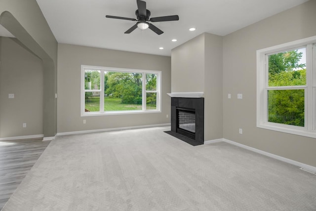 7658 Silver Lake Rd, Mounds View, MN 55112 - unfurnished living room with plenty of natural light, baseboards, a tile fireplace, and recessed lighting