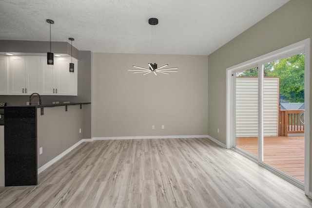7658 Silver Lake Rd, Mounds View, MN 55112 - unfurnished living room featuring light wood-style floors and baseboards