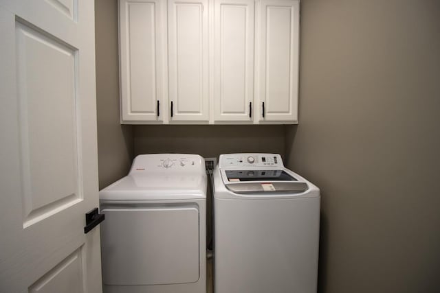 7658 Silver Lake Rd, Mounds View, MN 55112 - laundry room featuring separate washer and dryer and cabinet space