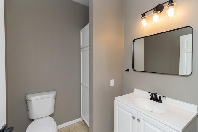 7658 Silver Lake Rd, Mounds View, MN 55112 - bathroom featuring toilet, vanity, baseboards, and tile patterned flooring