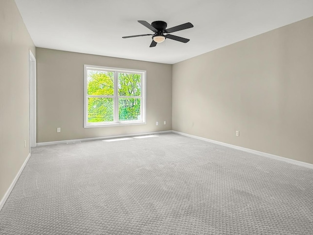 7658 Silver Lake Rd, Mounds View, MN 55112 - spare room with baseboards, ceiling fan, and light carpet