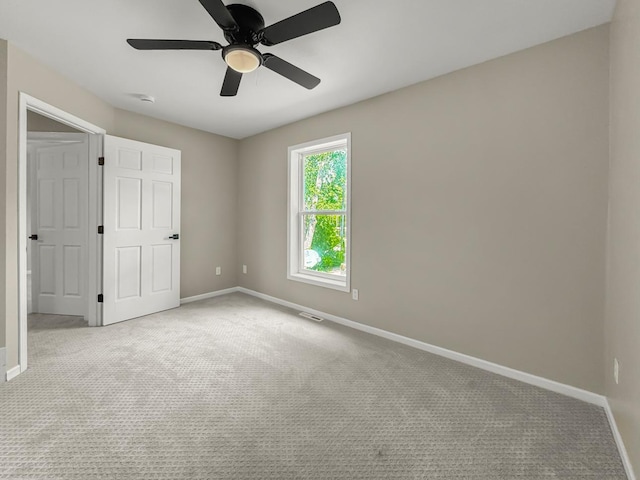 7658 Silver Lake Rd, Mounds View, MN 55112 - unfurnished bedroom with carpet flooring, baseboards, and ceiling fan