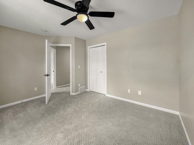 7658 Silver Lake Rd, Mounds View, MN 55112 - unfurnished bedroom with carpet flooring, baseboards, a closet, and ceiling fan