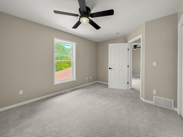 7658 Silver Lake Rd, Mounds View, MN 55112 - unfurnished bedroom with carpet flooring, baseboards, and a ceiling fan