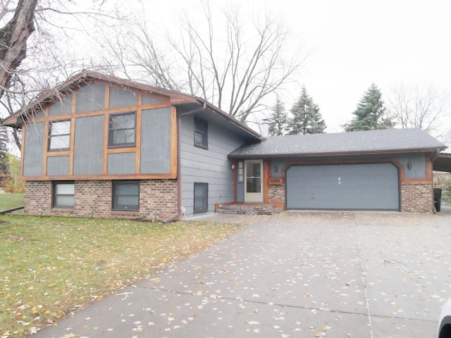1996 Kingston Ave E, Maplewood, MN 55109 - view of front facade featuring brick siding, driveway, an attached garage, and a front lawn