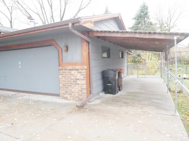 1996 Kingston Ave E, Maplewood, MN 55109 - view of home's exterior featuring concrete driveway, brick siding, and a garage