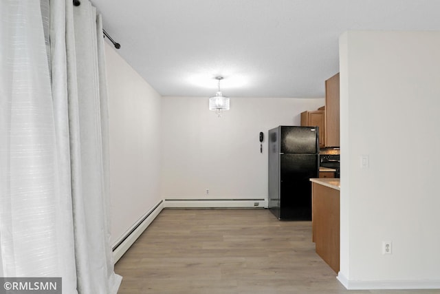 2800 Hillsboro Ave N Unit 108, New Hope, MN 55427 - kitchen with freestanding refrigerator, light wood finished floors, a baseboard radiator, brown cabinets, and range