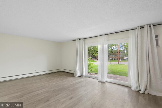 2800 Hillsboro Ave N Unit 108, New Hope, MN 55427 - unfurnished room featuring light wood-style floors and a textured ceiling