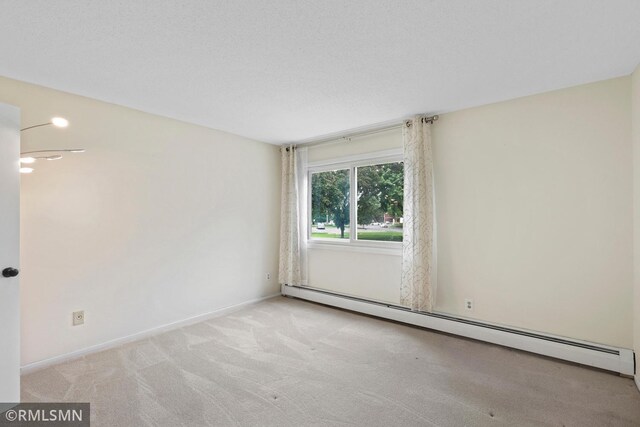 2800 Hillsboro Ave N Unit 108, New Hope, MN 55427 - unfurnished room featuring a baseboard heating unit, carpet floors, and baseboards
