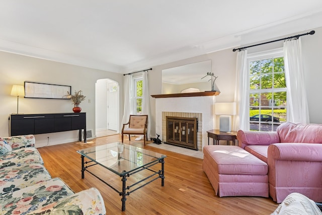 5604 14th Ave S, Minneapolis, MN 55417 - living room with plenty of natural light, wood finished floors, arched walkways, and a brick fireplace