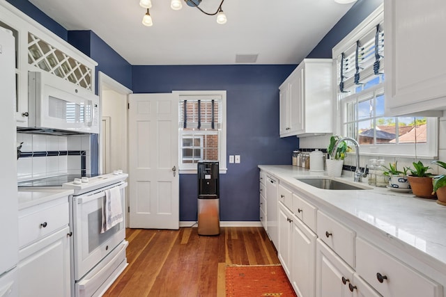 5604 14th Ave S, Minneapolis, MN 55417 - kitchen featuring white appliances, a sink, wood finished floors, white cabinets, and baseboards