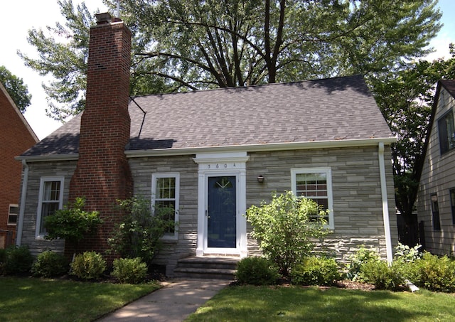 5604 14th Ave S, Minneapolis, MN 55417 - cape cod-style house with stone siding, a chimney, and roof with shingles