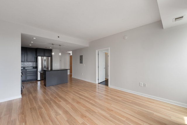 929 Portland Ave Unit 907, Minneapolis, MN 55404 - unfurnished living room featuring light wood-style floors, electric panel, and recessed lighting