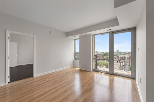 929 Portland Ave Unit 907, Minneapolis, MN 55404 - unfurnished room with light wood-style floors and expansive windows