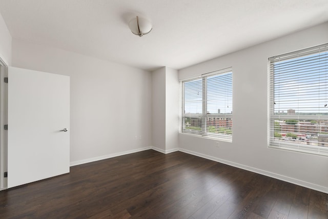 929 Portland Ave Unit 907, Minneapolis, MN 55404 - unfurnished room with dark wood-style flooring and baseboards
