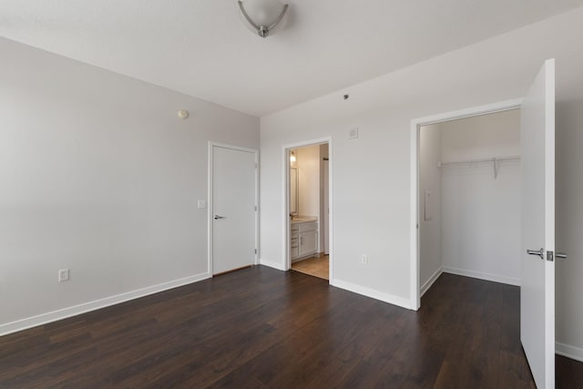 929 Portland Ave Unit 907, Minneapolis, MN 55404 - unfurnished bedroom featuring dark wood-style flooring, a closet, ensuite bath, and a spacious closet