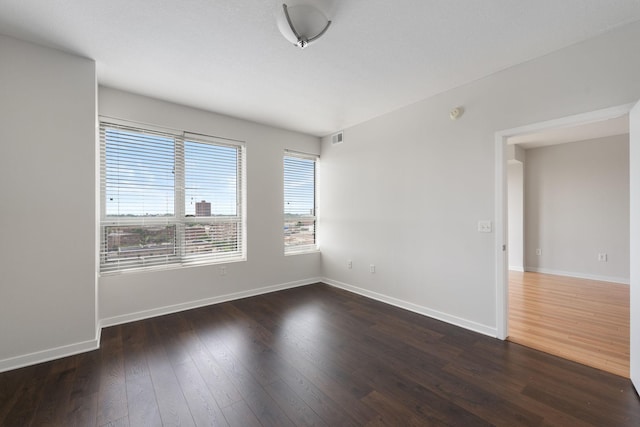 929 Portland Ave Unit 907, Minneapolis, MN 55404 - spare room featuring dark wood-style floors and baseboards