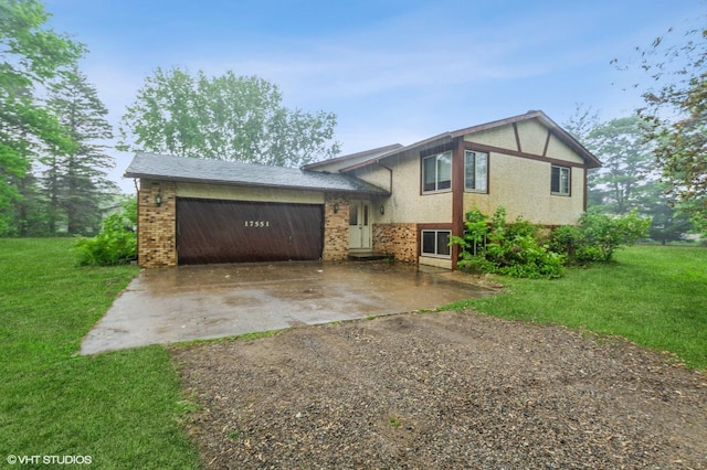 17551 London St NE, Ham Lake, MN 55304 - split level home featuring concrete driveway, an attached garage, a front yard, and brick siding