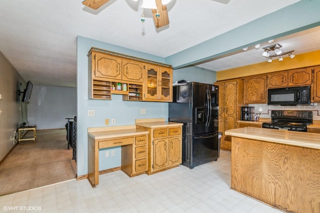 17551 London St NE, Ham Lake, MN 55304 - kitchen featuring black appliances, light countertops, brown cabinets, ceiling fan, and glass insert cabinets