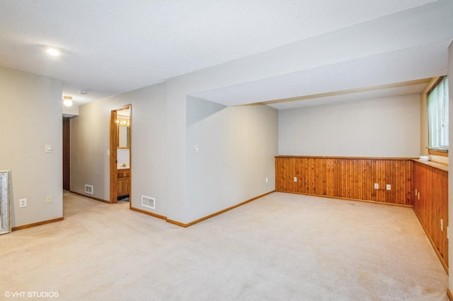 17551 London St NE, Ham Lake, MN 55304 - below grade area featuring light colored carpet, wooden walls, and a wainscoted wall