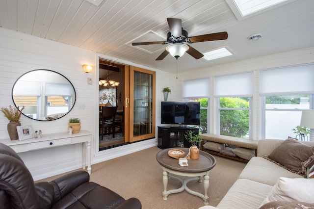 229 30th Ave N, Fargo, ND 58102 - carpeted living area with a skylight, wood ceiling, a ceiling fan, wood walls, and a chandelier