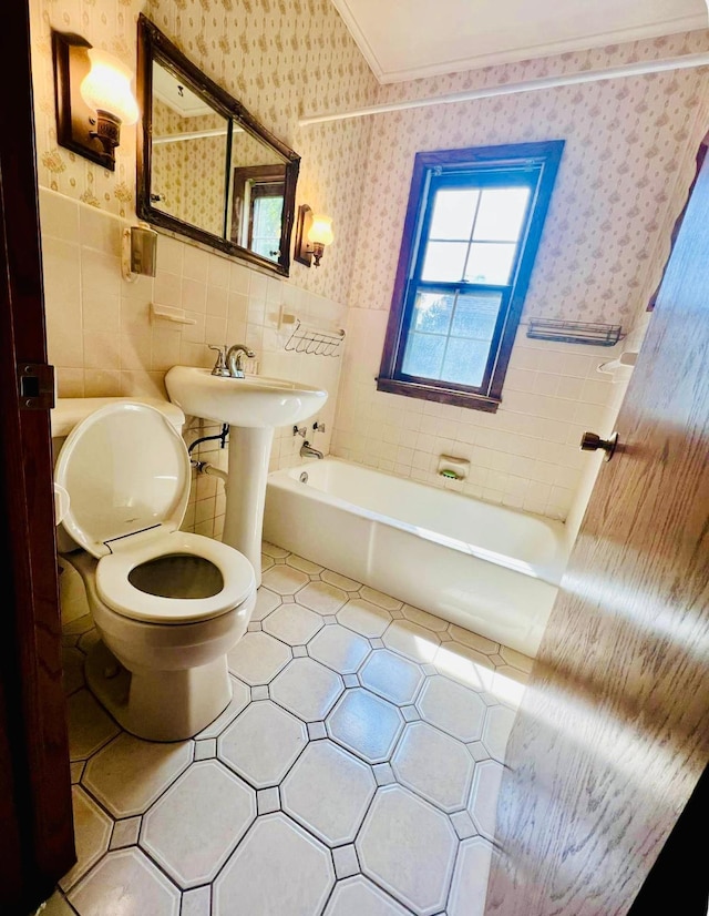 150 Park St W, South Saint Paul, MN 55075 - full bathroom with wallpapered walls, toilet, wainscoting, and tile walls