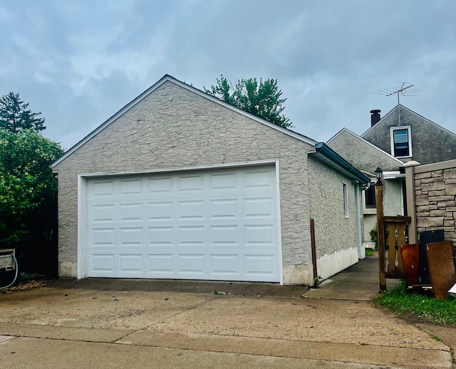 150 Park St W, South Saint Paul, MN 55075 - view of side of property with stucco siding, a chimney, and driveway