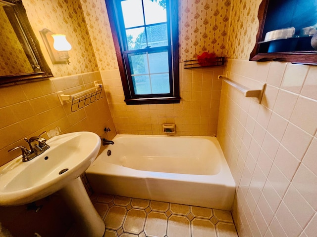 150 Park St W, South Saint Paul, MN 55075 - full bath featuring wallpapered walls, tile walls, a tub, a wainscoted wall, and tile patterned floors