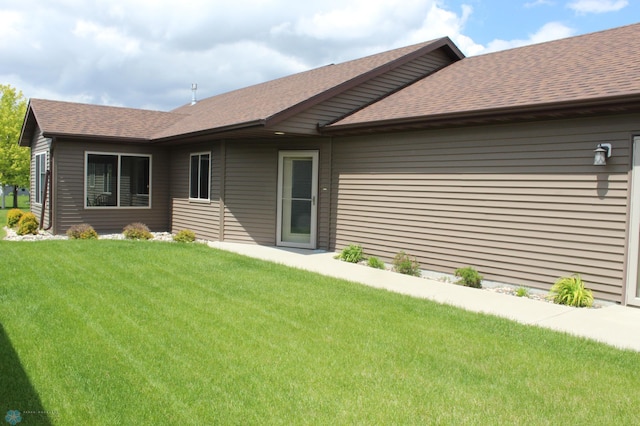 3441 25th St S, Moorhead, MN 56560 - back of house with a shingled roof and a yard