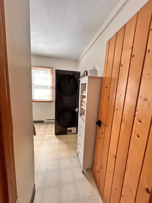 2145 Big Deep Lake Dr NW, Hackensack, MN 56452 - hallway featuring estacked washer and dryer, light flooring, and a baseboard heating unit