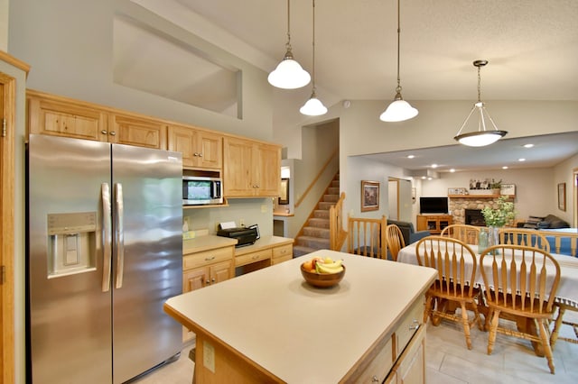 1518 4th Ave N, Sartell, MN 56377 - kitchen featuring appliances with stainless steel finishes, light brown cabinets, open floor plan, a fireplace, and a kitchen island