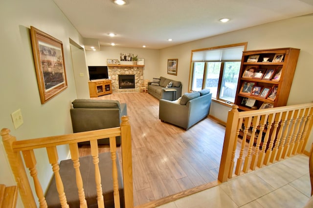 1518 4th Ave N, Sartell, MN 56377 - living area with a stone fireplace, wood finished floors, recessed lighting, and baseboards