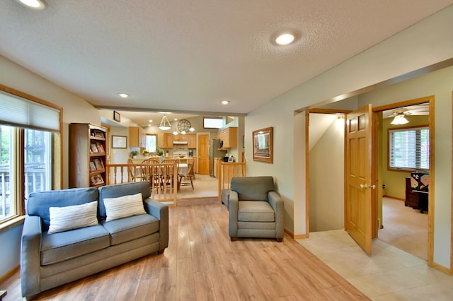 1518 4th Ave N, Sartell, MN 56377 - living area featuring plenty of natural light, light wood-style flooring, a textured ceiling, recessed lighting, and baseboards