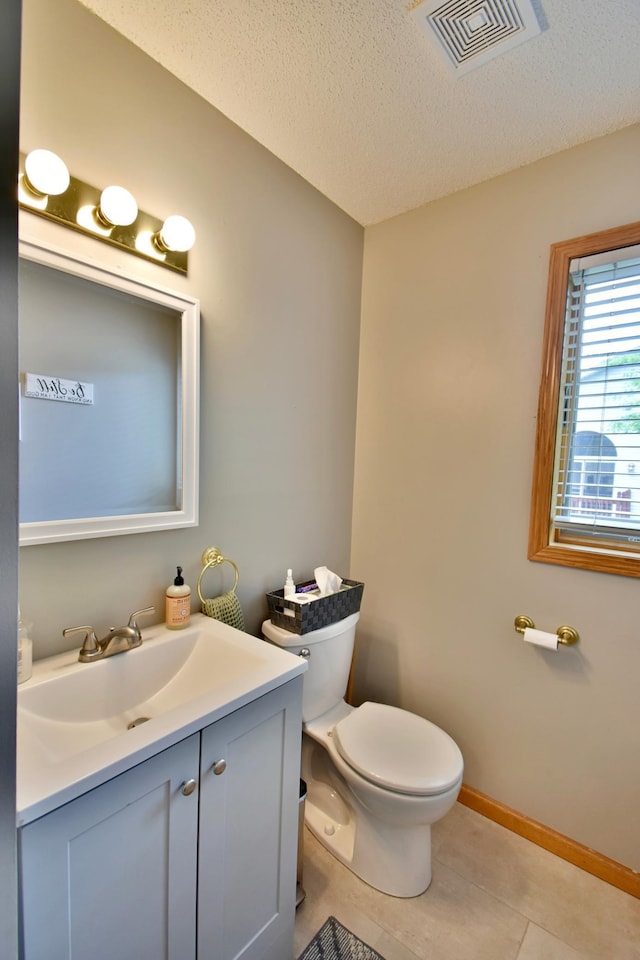 1518 4th Ave N, Sartell, MN 56377 - half bath featuring vanity, toilet, a textured ceiling, and baseboards