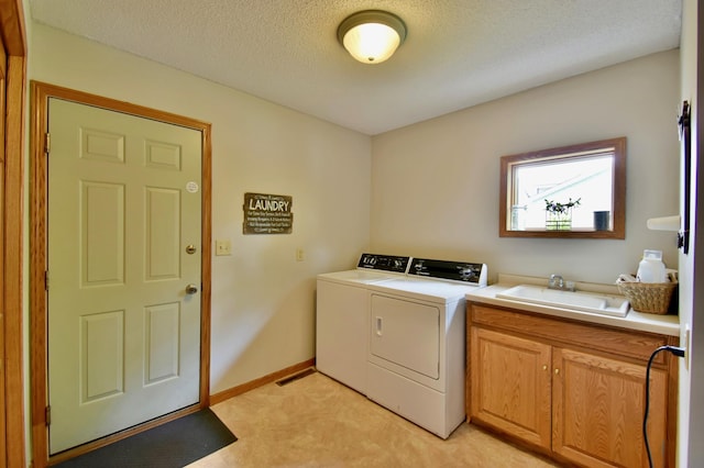 1518 4th Ave N, Sartell, MN 56377 - washroom featuring cabinet space, washing machine and clothes dryer, a textured ceiling, light colored carpet, and baseboards