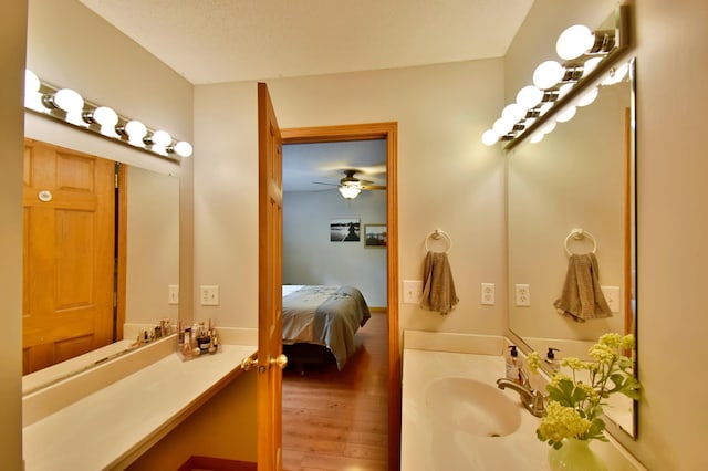 1518 4th Ave N, Sartell, MN 56377 - ensuite bathroom featuring vanity, wood finished floors, and ceiling fan