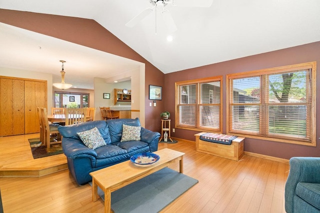 903 Ingalls Rd, Menomonie, WI 54751 - living area with lofted ceiling, light wood-style floors, ceiling fan, and baseboards