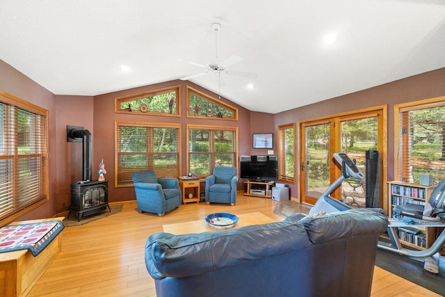 903 Ingalls Rd, Menomonie, WI 54751 - living room featuring a wood stove, lofted ceiling, a ceiling fan, and light wood-style floors
