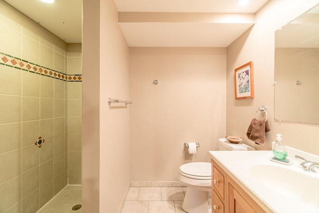 903 Ingalls Rd, Menomonie, WI 54751 - bathroom featuring vanity, tile patterned flooring, toilet, a tile shower, and baseboards