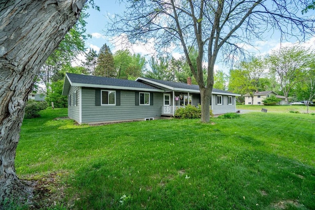 903 Ingalls Rd, Menomonie, WI 54751 - view of front facade with a front yard, a chimney, and a shingled roof