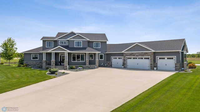 787 Riverbend Rd, Oxbow, ND 58047 - craftsman-style house with covered porch, a garage, stone siding, driveway, and a front yard