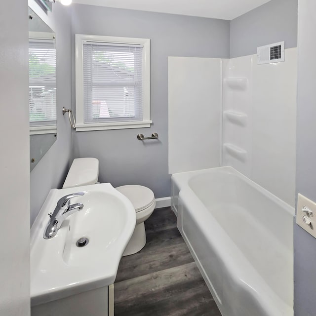 2718 Morgan Ave N, Minneapolis, MN 55411 - full bath with toilet, wood finished floors, vanity, and baseboards