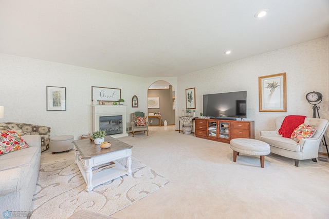 5916 Elm St N, Moorhead, MN 56560 - carpeted living area with arched walkways, a glass covered fireplace, and recessed lighting