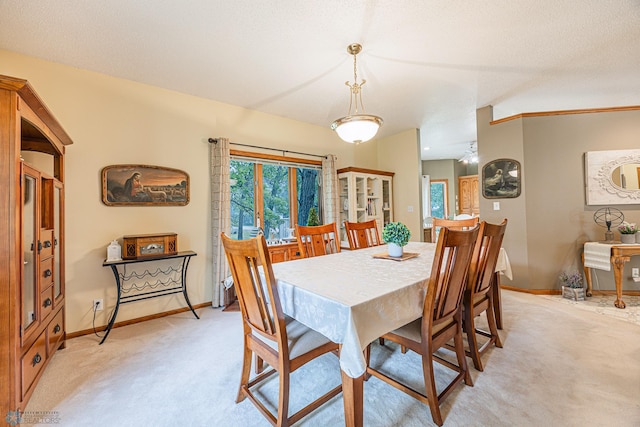 5916 Elm St N, Moorhead, MN 56560 - dining area with light colored carpet, baseboards, and plenty of natural light