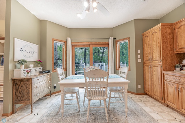5916 Elm St N, Moorhead, MN 56560 - dining room featuring light flooring, a ceiling fan, a textured ceiling, and baseboards