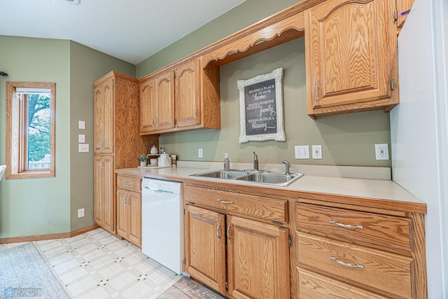 5916 Elm St N, Moorhead, MN 56560 - kitchen with white dishwasher, a sink, light floors, light countertops, and baseboards