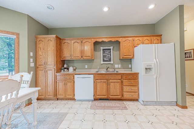5916 Elm St N, Moorhead, MN 56560 - kitchen with white appliances, a sink, light countertops, light flooring, and recessed lighting