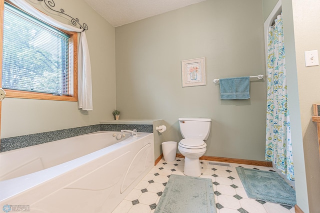 5916 Elm St N, Moorhead, MN 56560 - bathroom with toilet, baseboards, a garden tub, tile patterned floors, and a shower with shower curtain