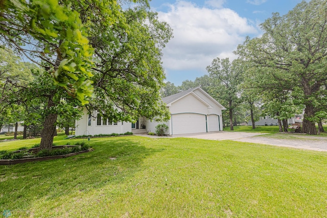 5916 Elm St N, Moorhead, MN 56560 - view of property hidden behind natural elements featuring concrete driveway, a garage, and a front yard