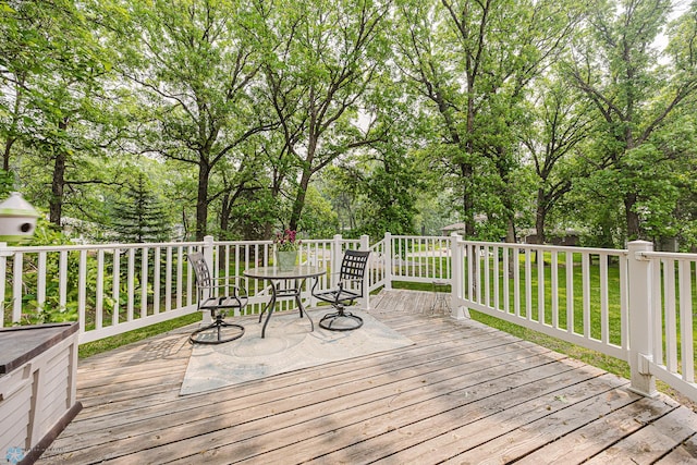 5916 Elm St N, Moorhead, MN 56560 - wooden terrace featuring outdoor dining space and view of wooded area